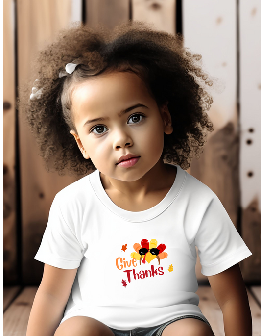 Toddler girls wearing white T-Shirt " Give Thanks" with Turkey head on front.
