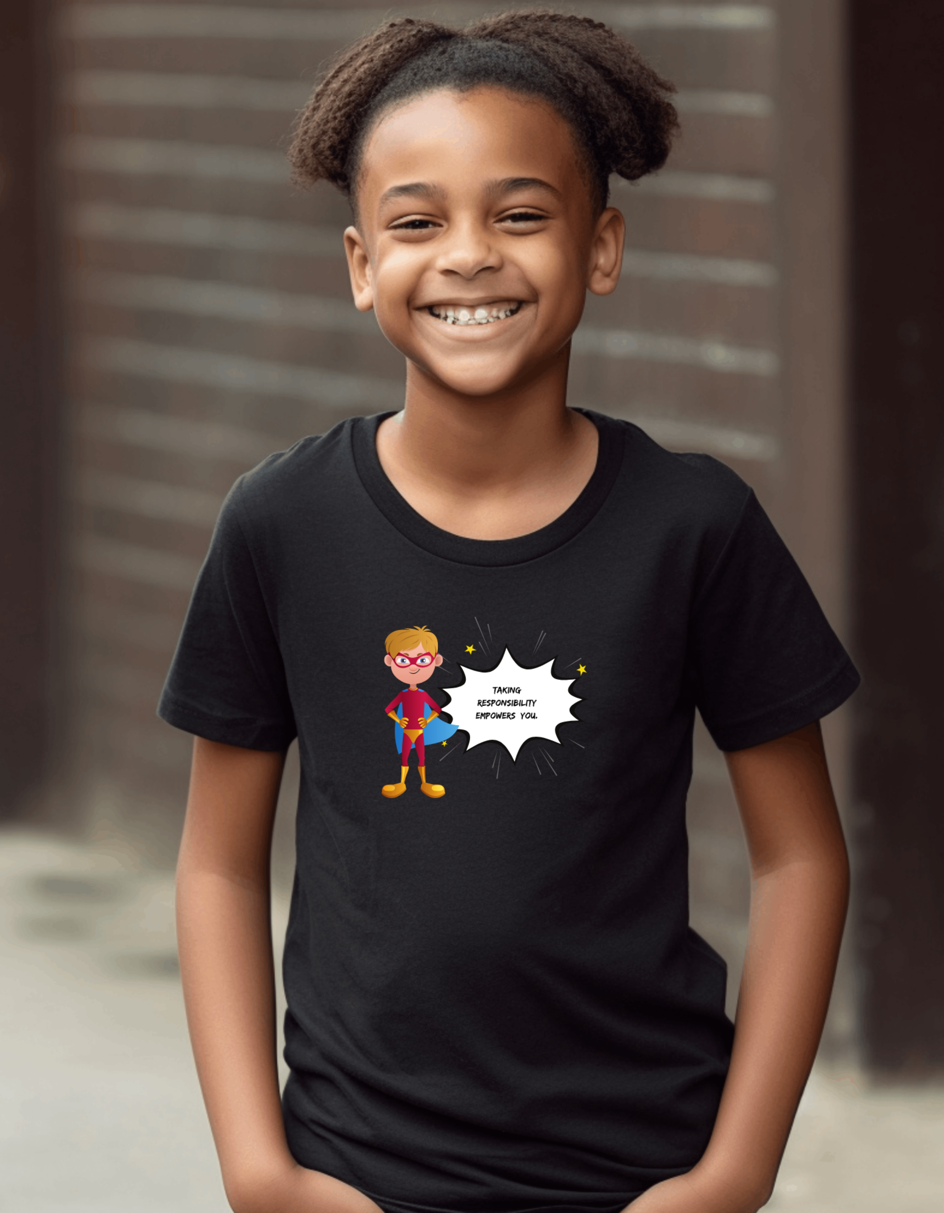 Youth Boy wearing black T-shirt with " Taking responsibility empower you" motivational graphic on front.