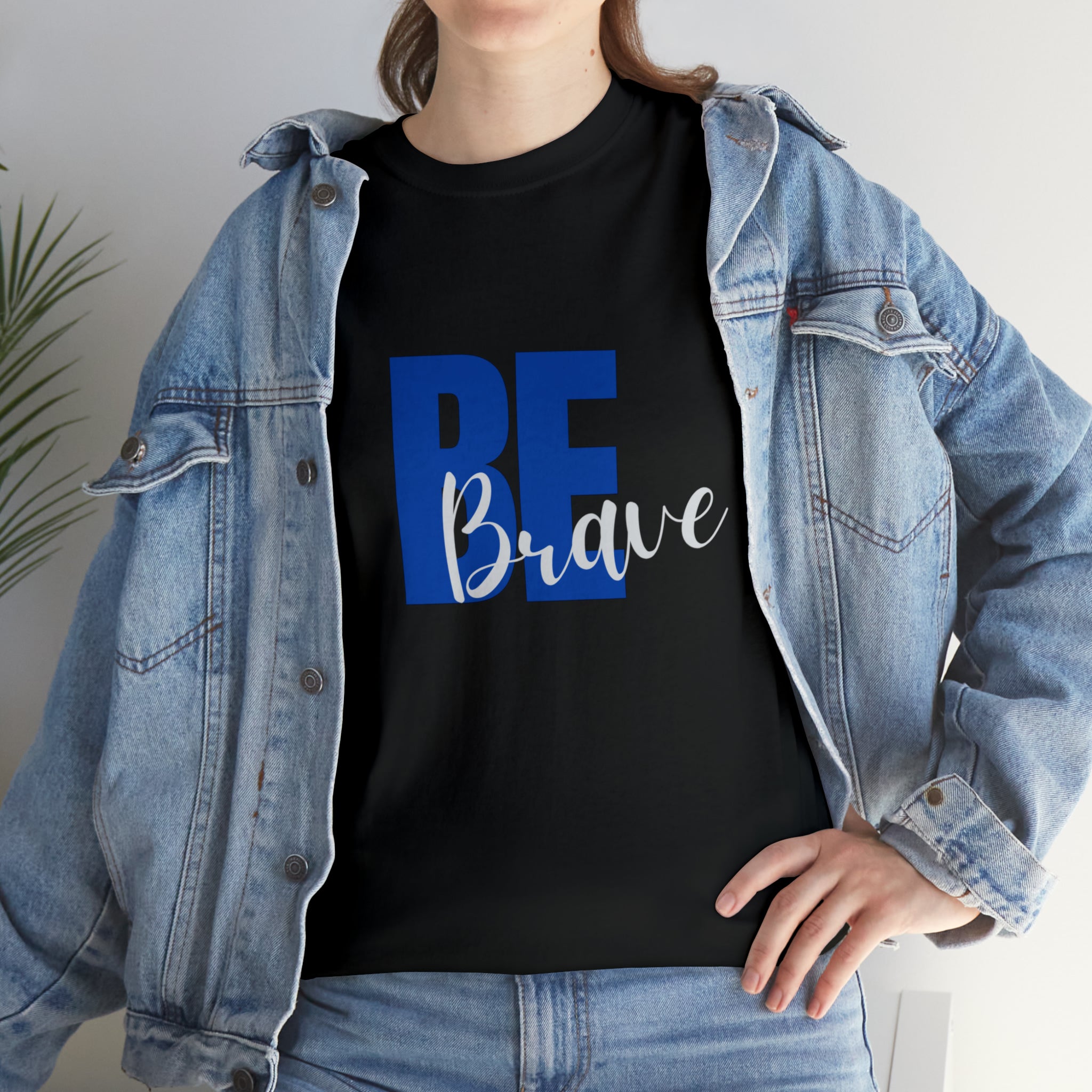 Adult women wearing  black T-Shirt and Jean jacket with "Be Brave" motivational image on front.