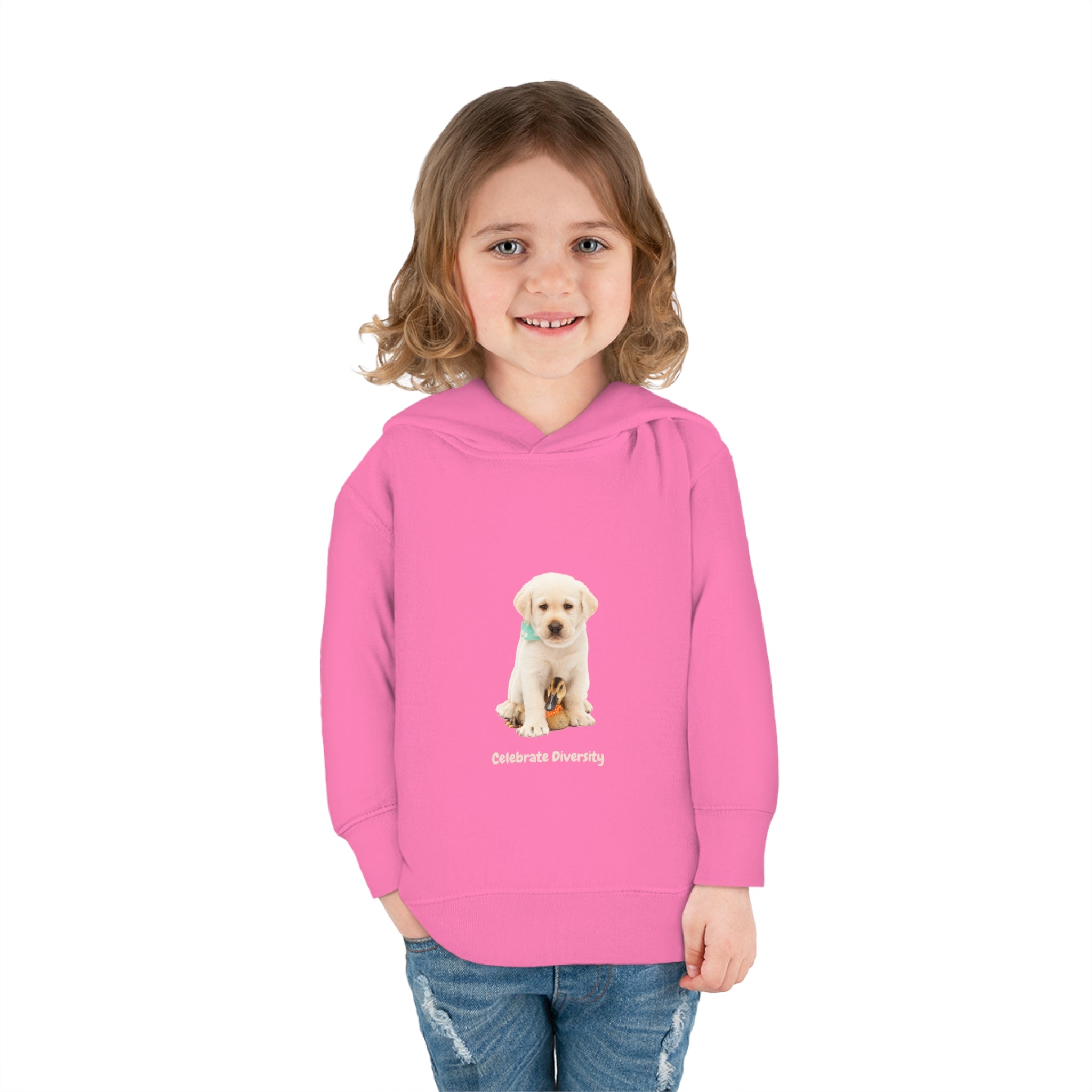 Toddler girl wearing pink unisex hoodie with "Celebrate Diversity" inspired graphic with puppy and duck on front.