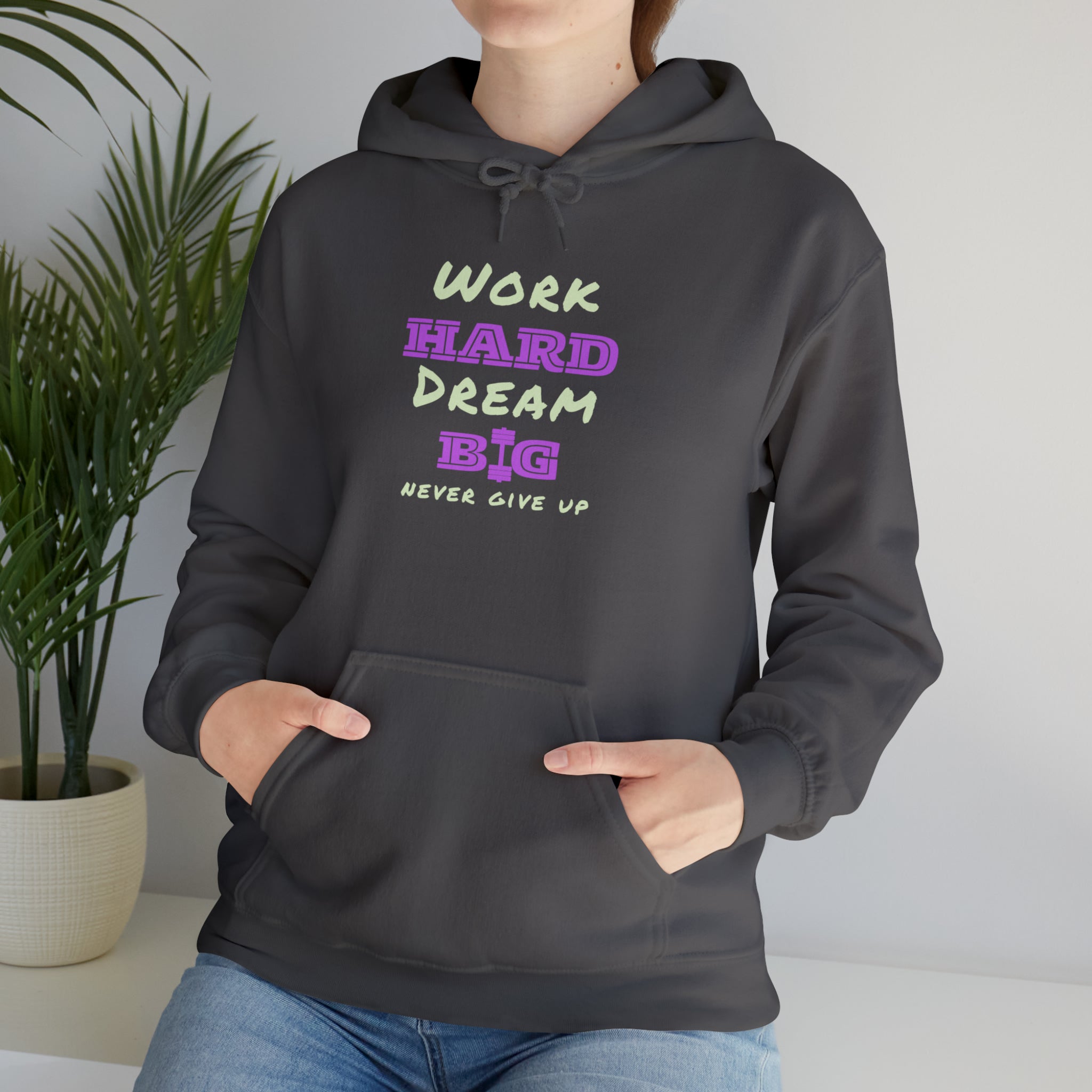 Adult Model wearing Charcoal Hoodie with Work Hard Dream Big Never Give Up Image on front.