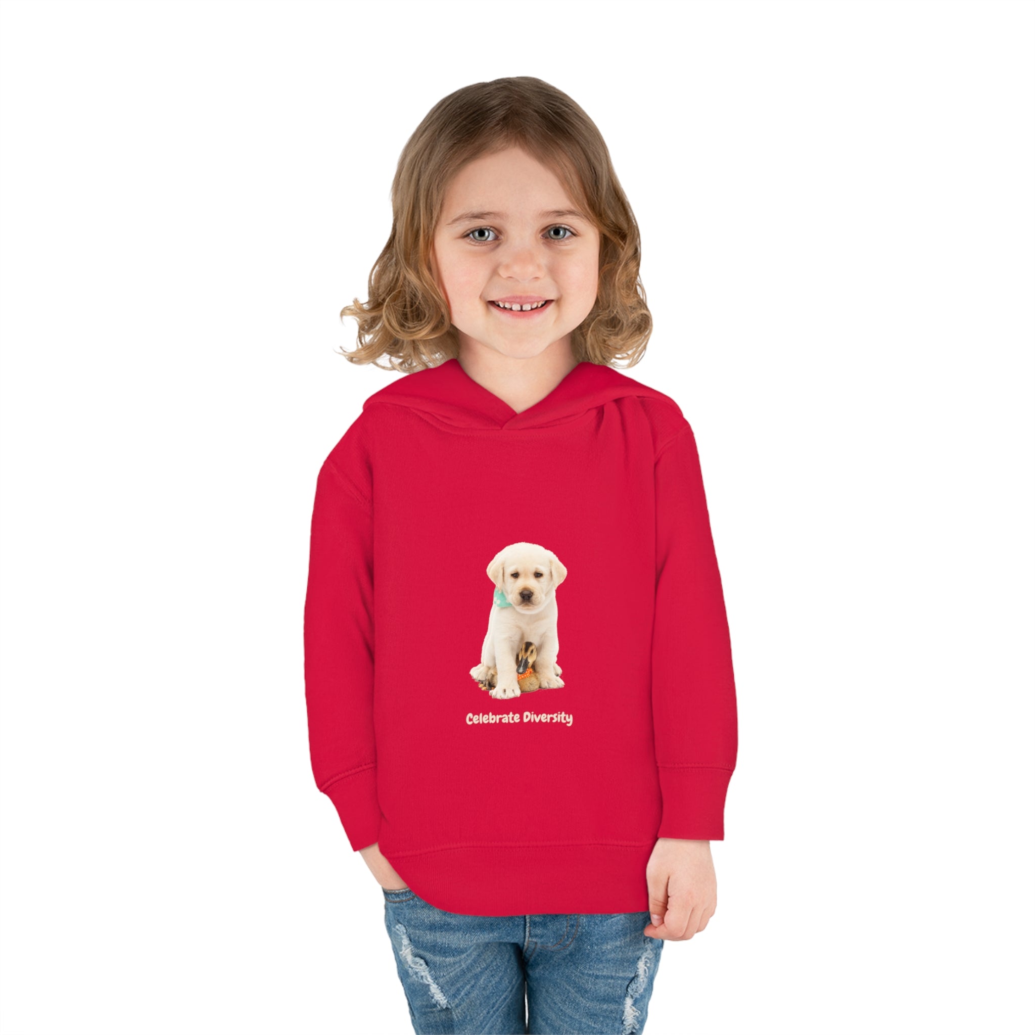 Toddler girl wearing red unisex hoodie with "Celebrate Diversity" inspired graphic with puppy and duck on front.