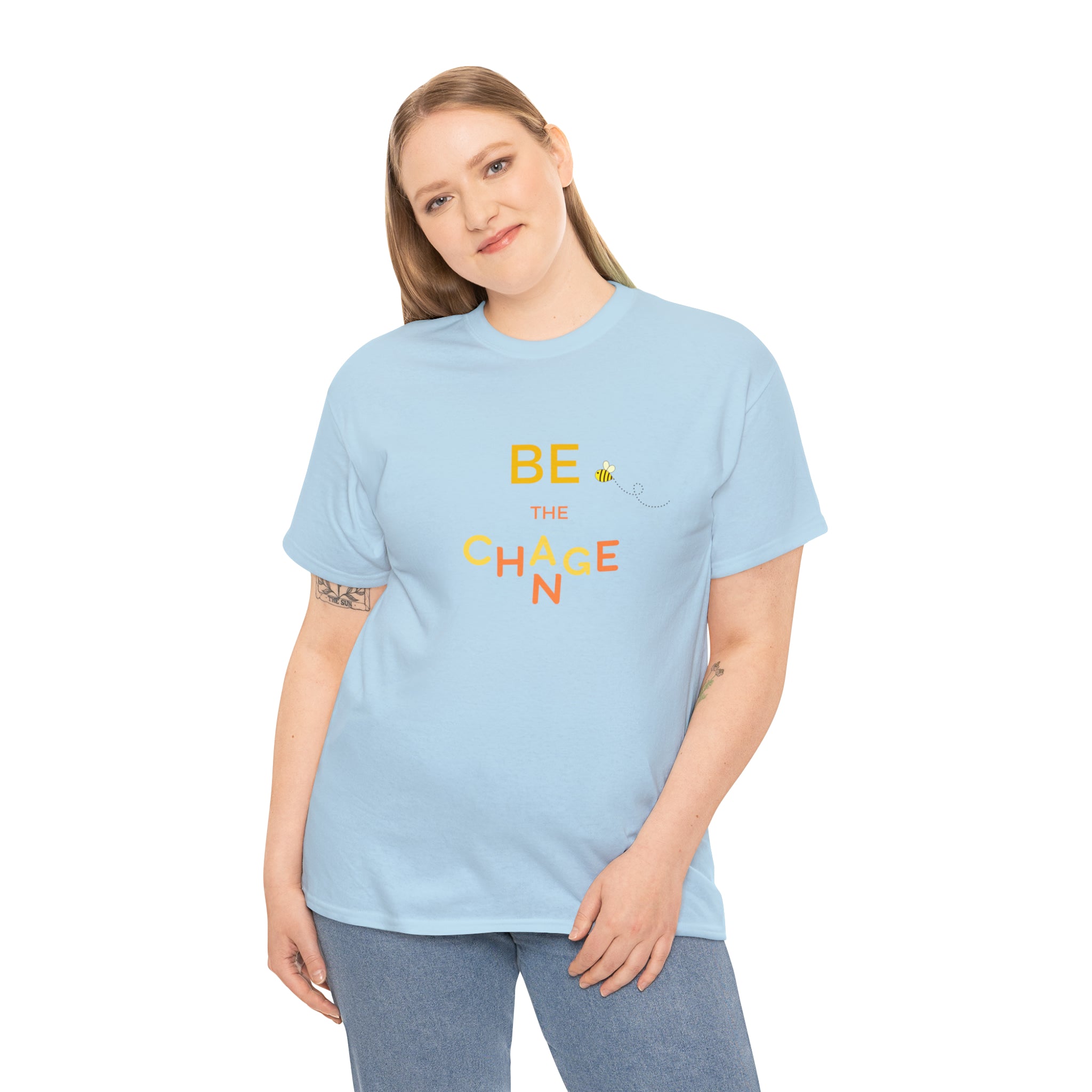 Adult Women wearing carolina blue T-Shirt with "Be The Change" motivational image on front.