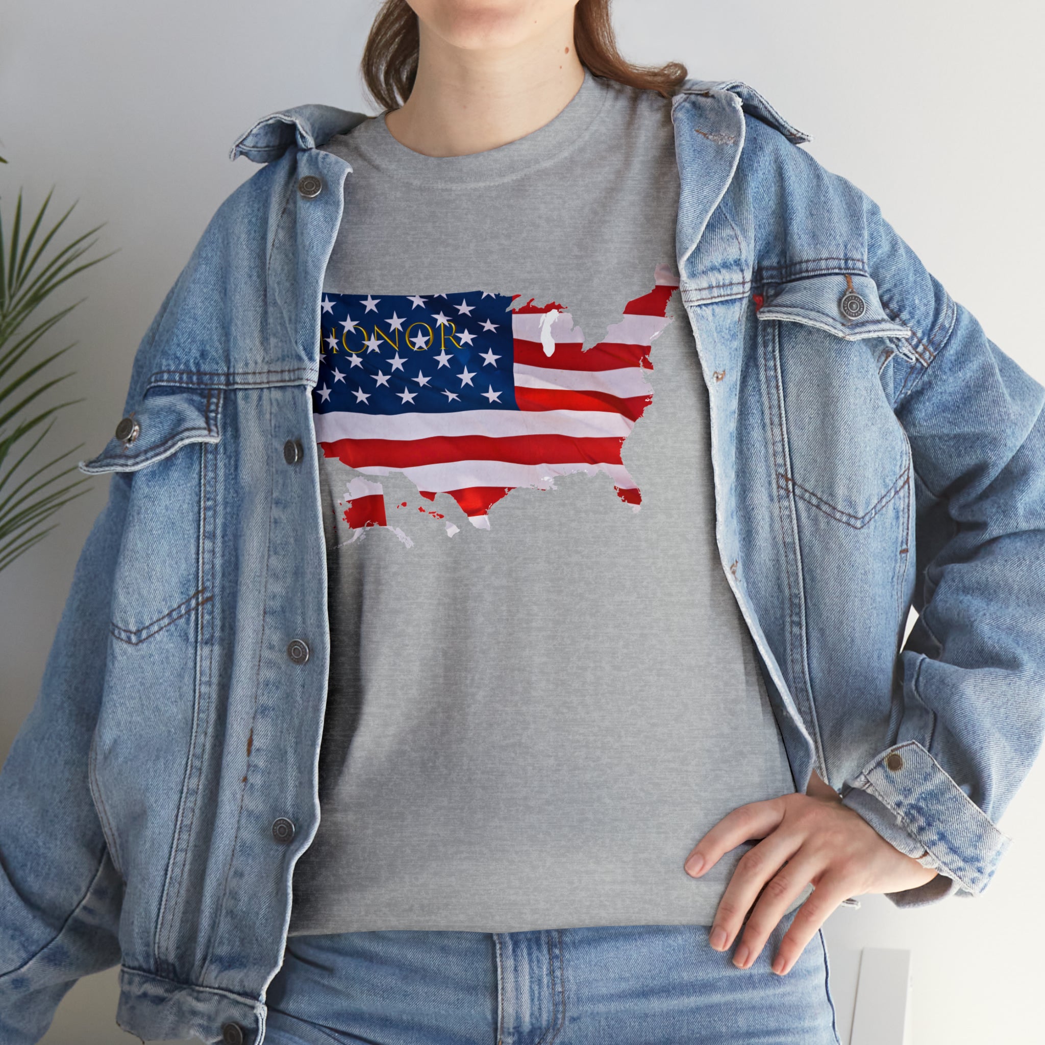 Adult female wearing sports grey T-Shirt with "Honor USA" inspired American as a Flag graphic on front, with jean jacket