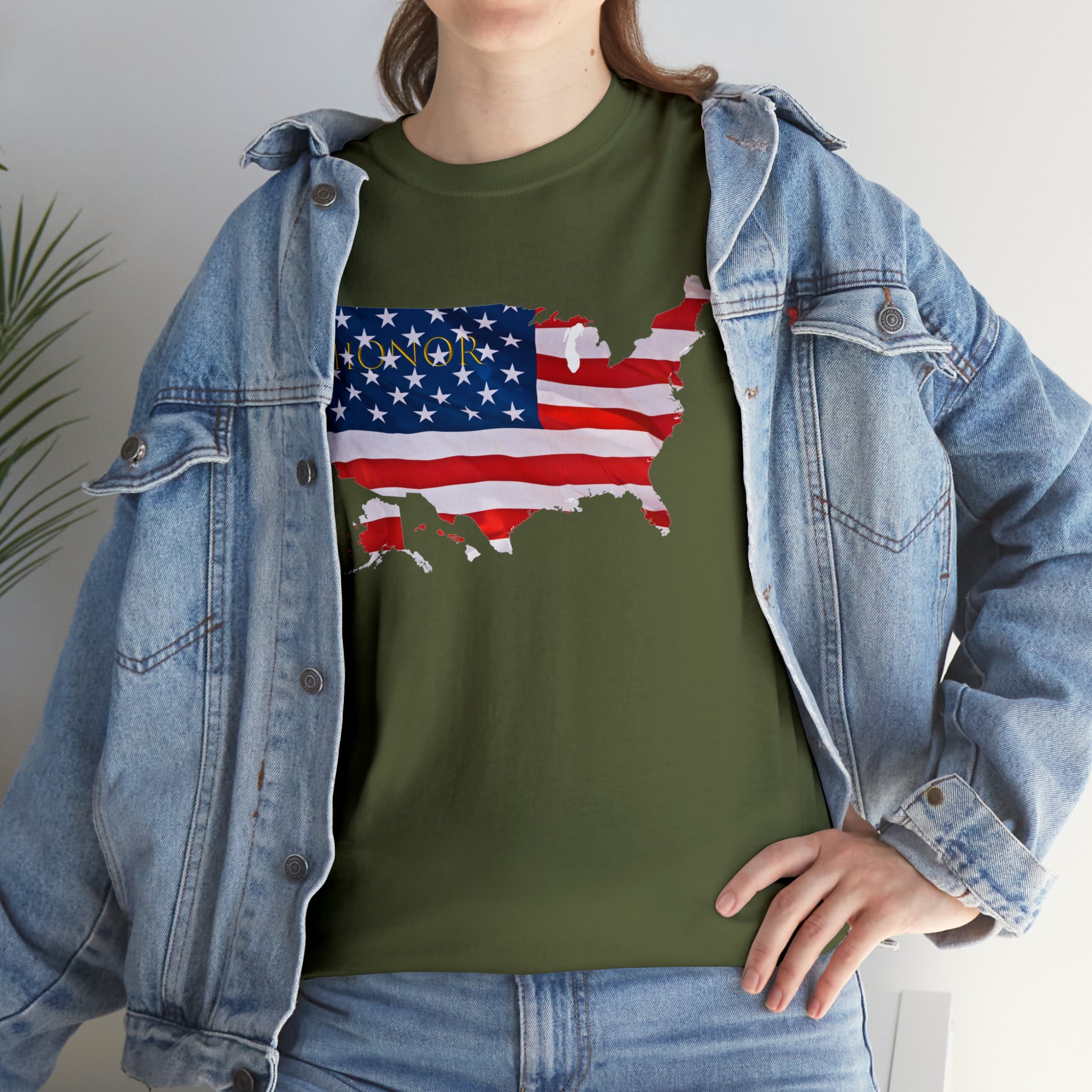 Adult female wearing military green T-Shirt with "Honor USA" inspired American as a Flag graphic on front, with jean jacket