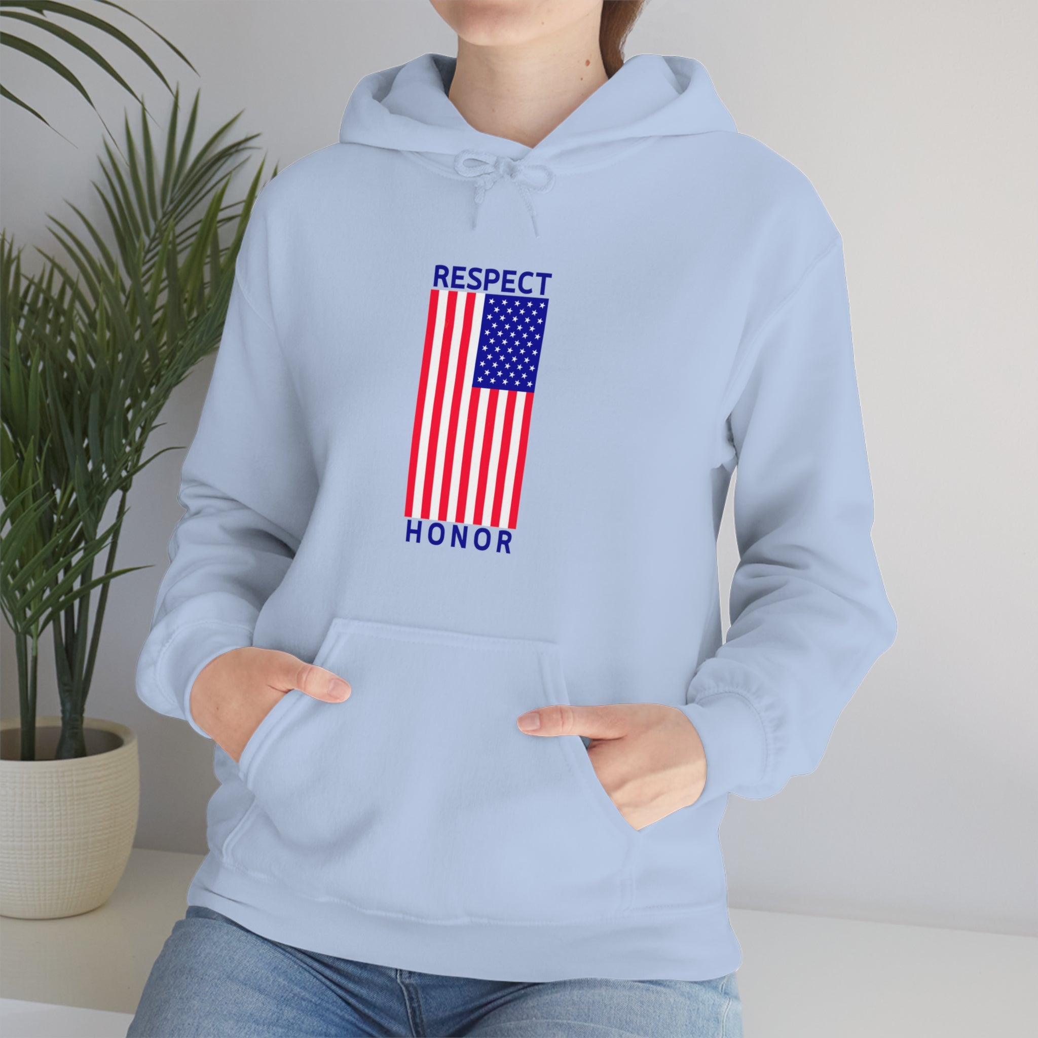 Adult female front view wearing light blue hoodie with "Respect Honor" Inspired Classic American Flag on front.