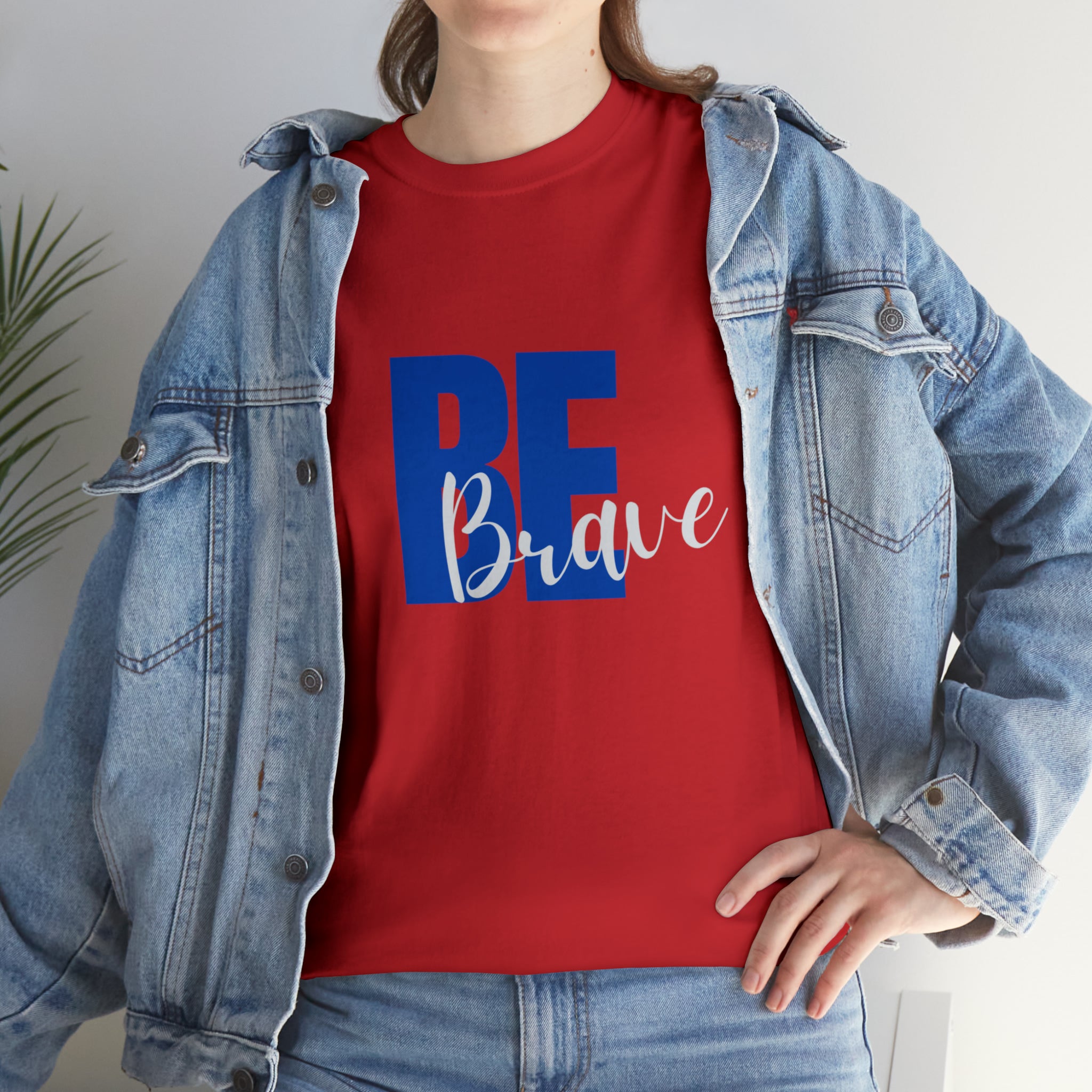 Adult women wearing red T-Shirt and Jean jacket with "Be Brave" motivational image on front.