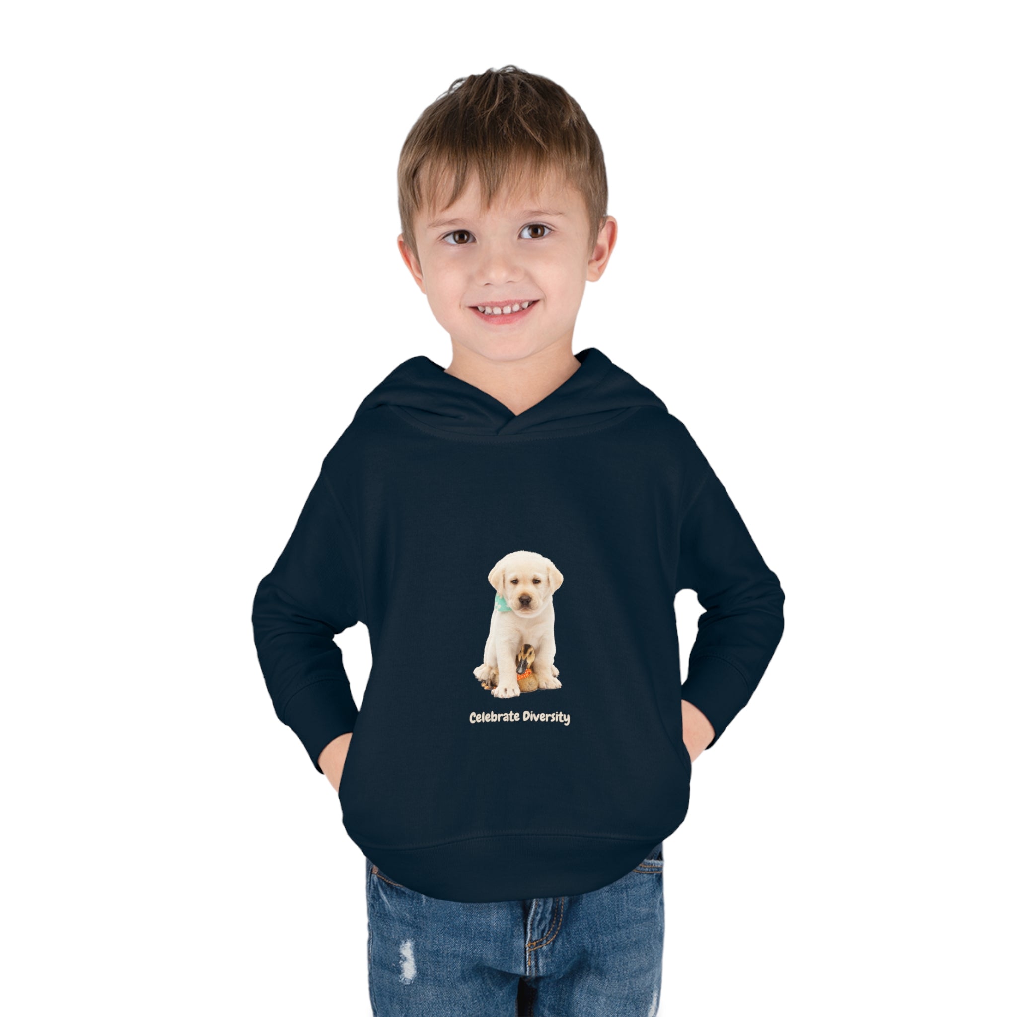 Toddler boy wearing navy unisex hoodie with "Celebrate Diversity" inspired graphic with puppy and duck on front.
