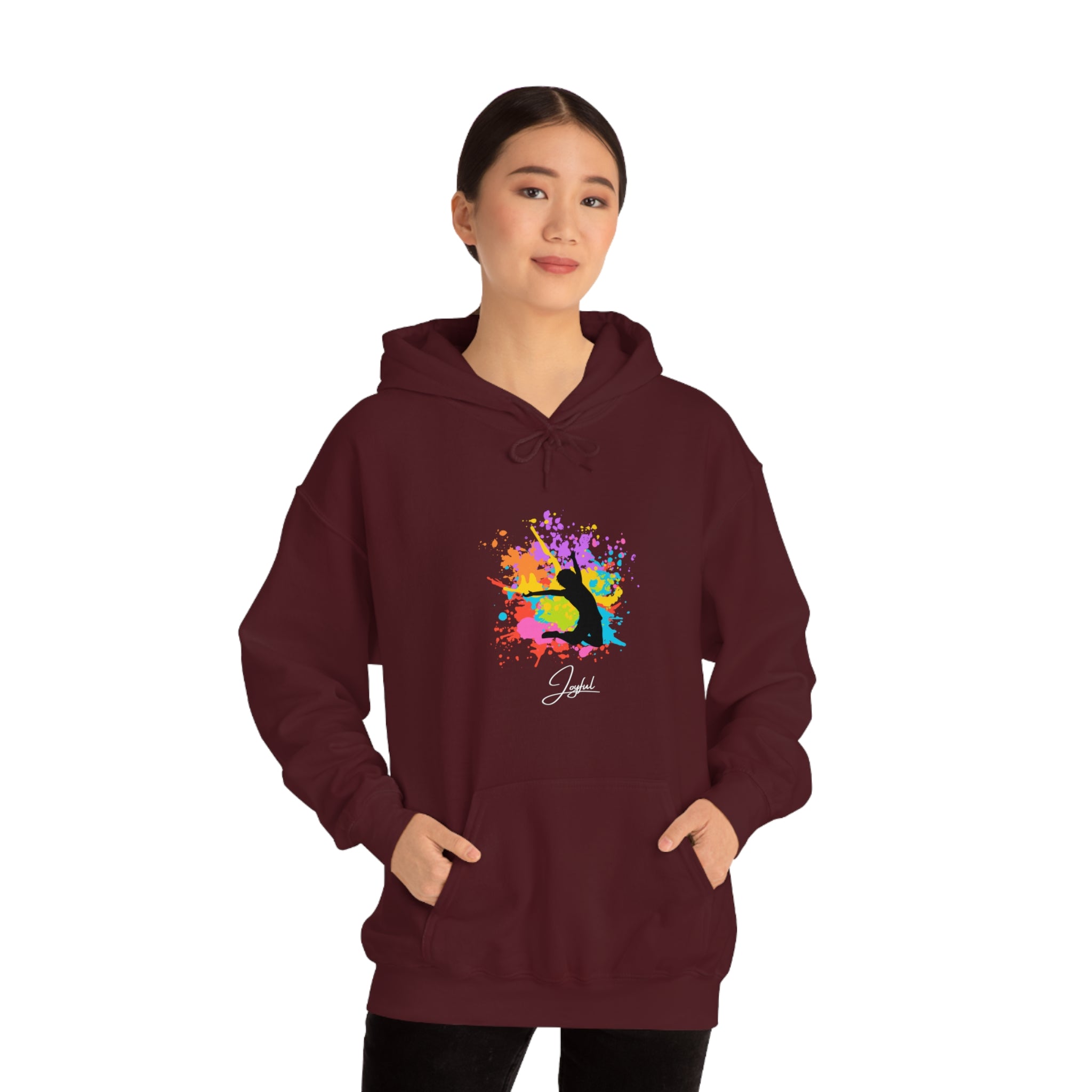 Adult female wearing maroon hoodie with "Joyful" graphic on front.