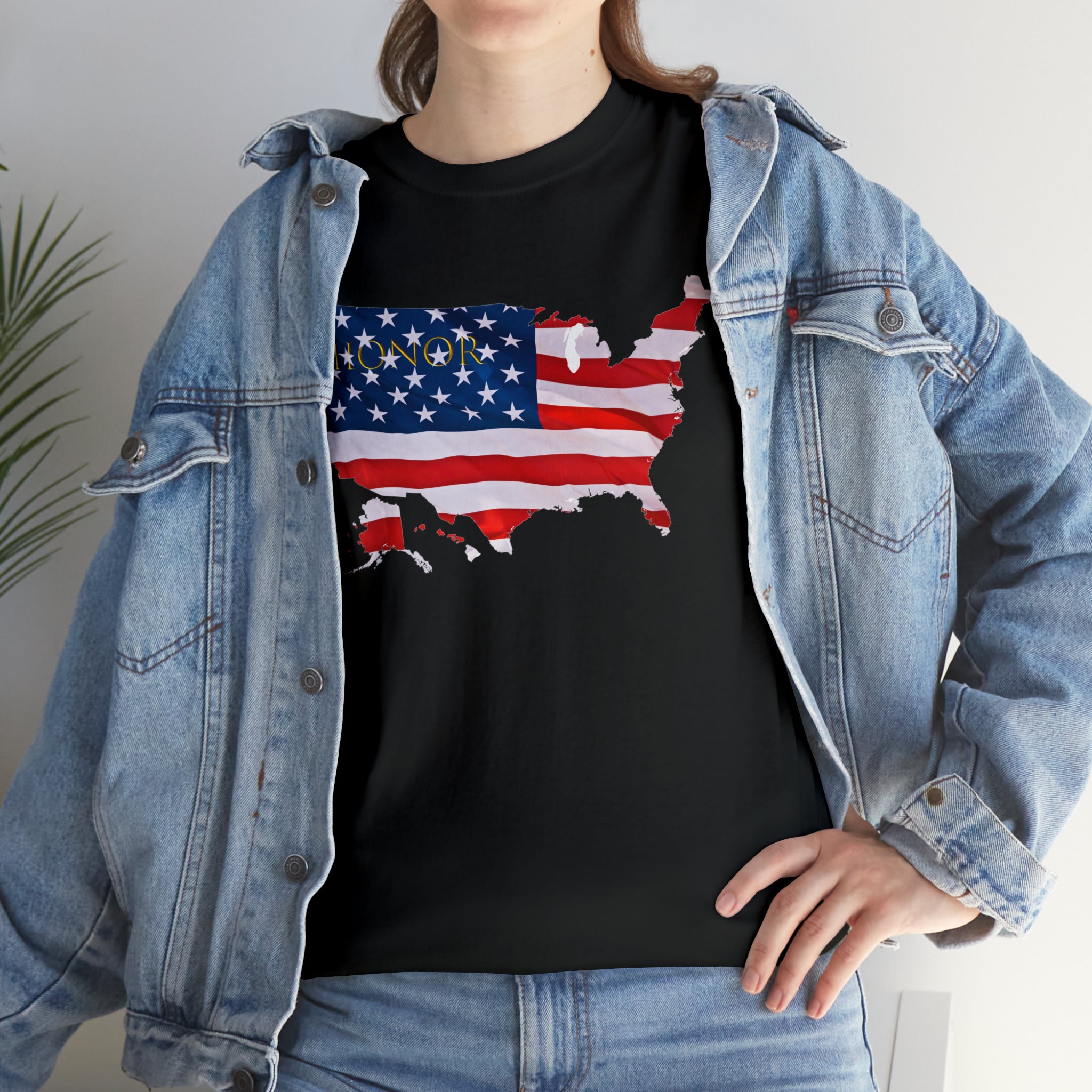 Adult female wearing black T-Shirt with "Honor USA" inspired American as a Flag graphic on front, with jean jacket
