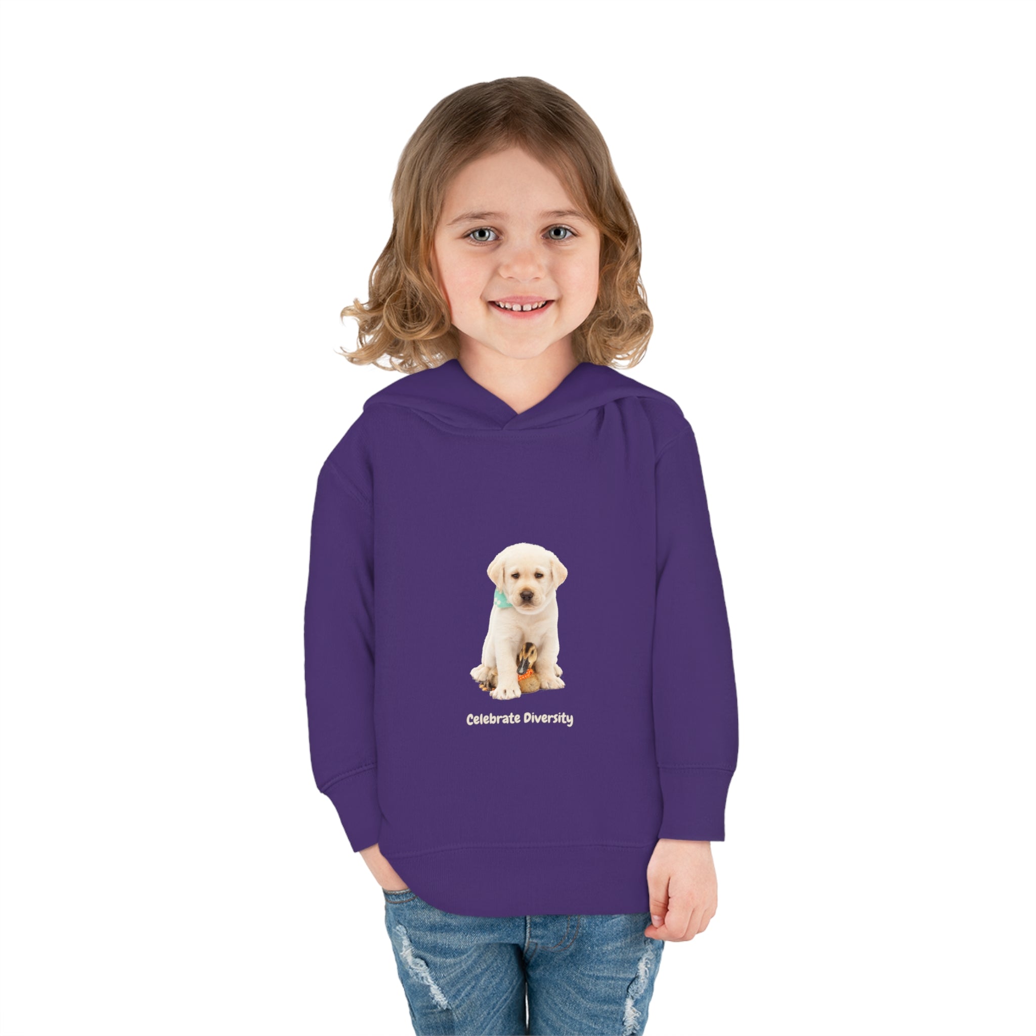 Toddler girl wearing purple unisex hoodie with "Celebrate Diversity" inspired graphic with puppy and duck on front.