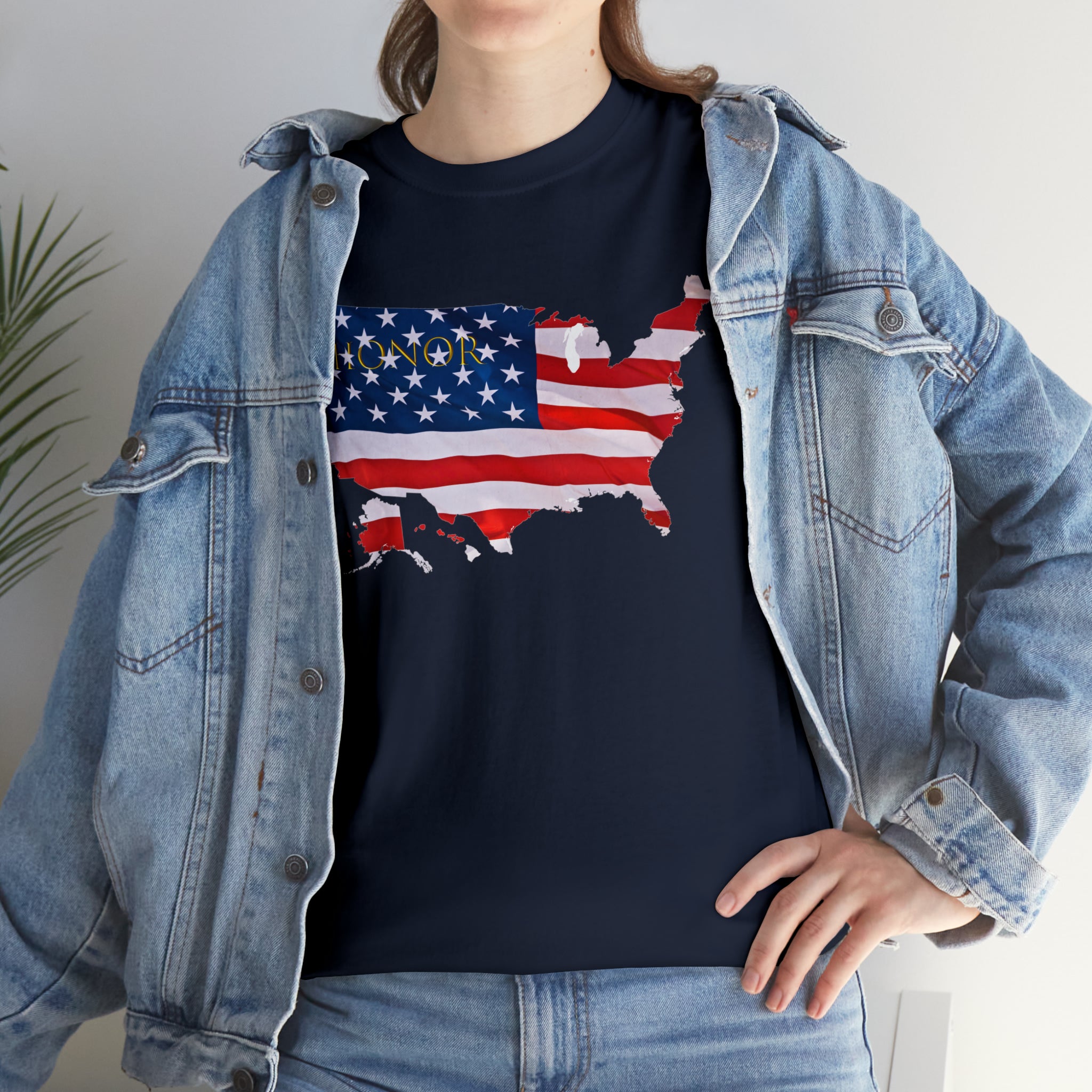 Adult female wearing navy T-Shirt with "Honor USA" inspired American as a Flag graphic on front, with jean jacket