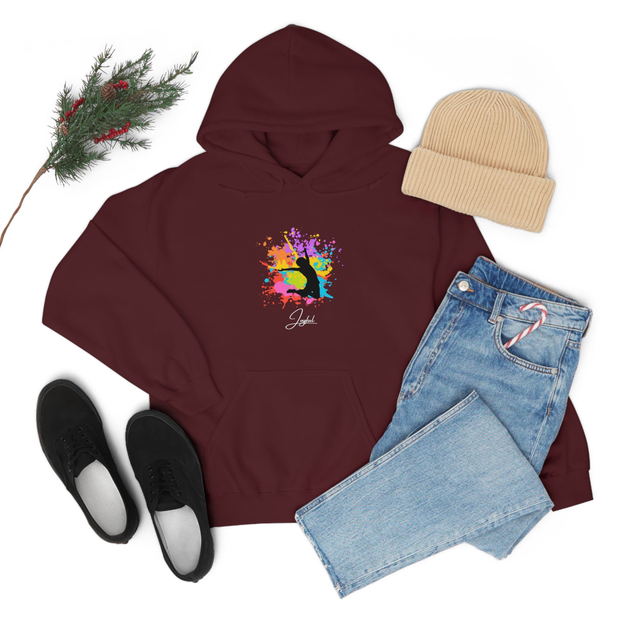 Adult outfit display with maroon hoodie with "Joyful " graphic on front, black shoes, blue jeans, tan hat .