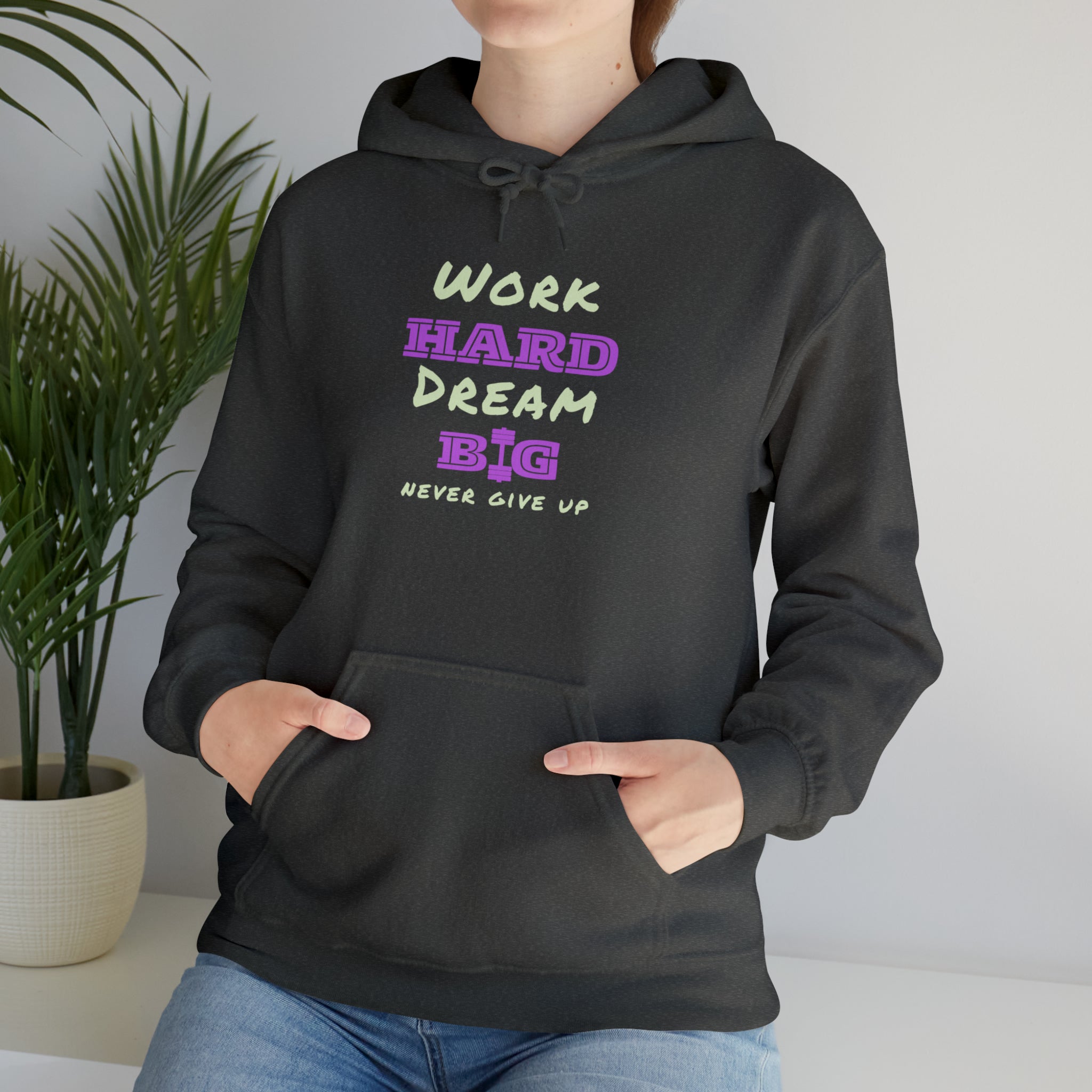 Adult Model wearing Charcoal Hoodie with Work Hard Dream Big Never Give Up Image on front.