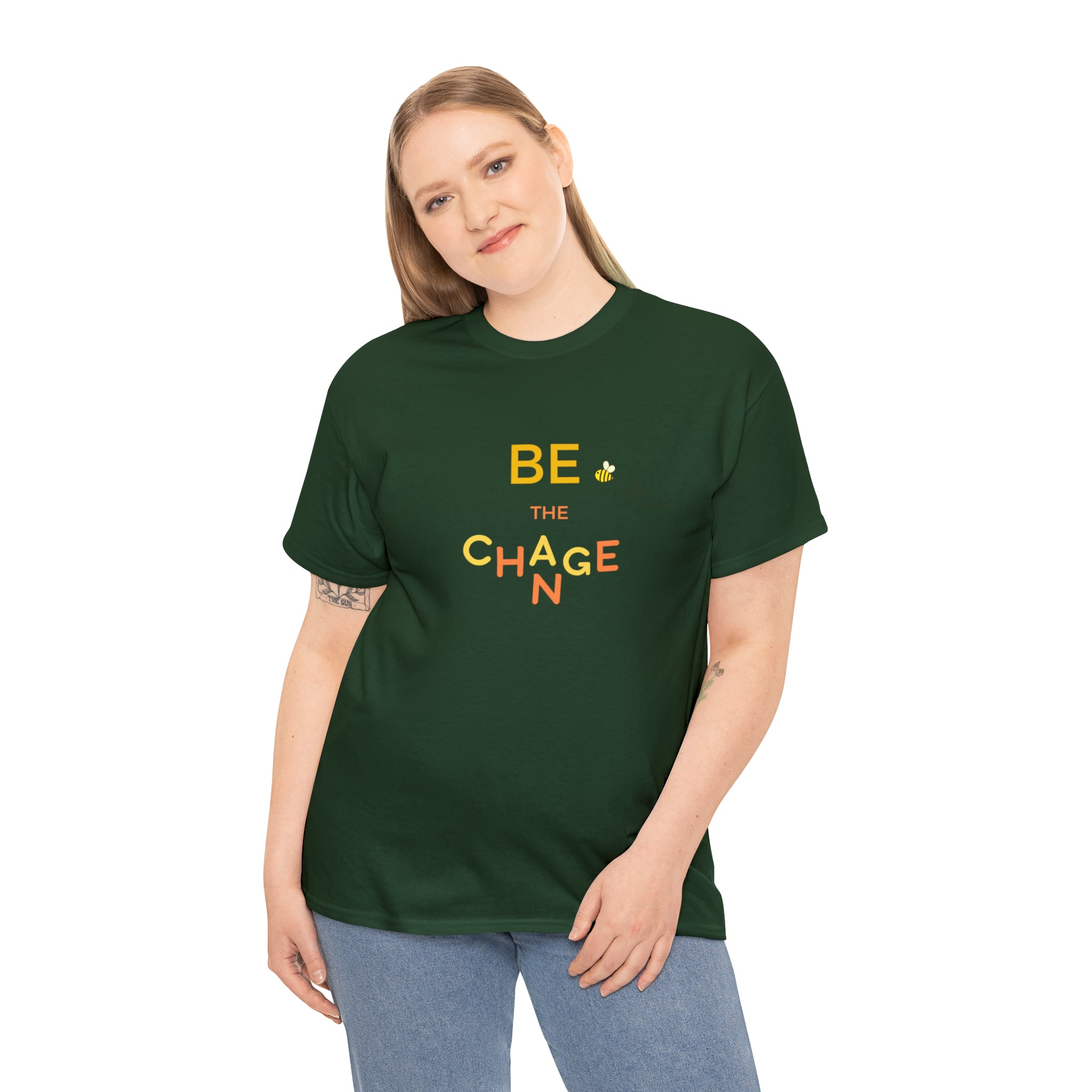 Adult Women wearing forest green T-Shirt with "Be The Change" motivational image on front.