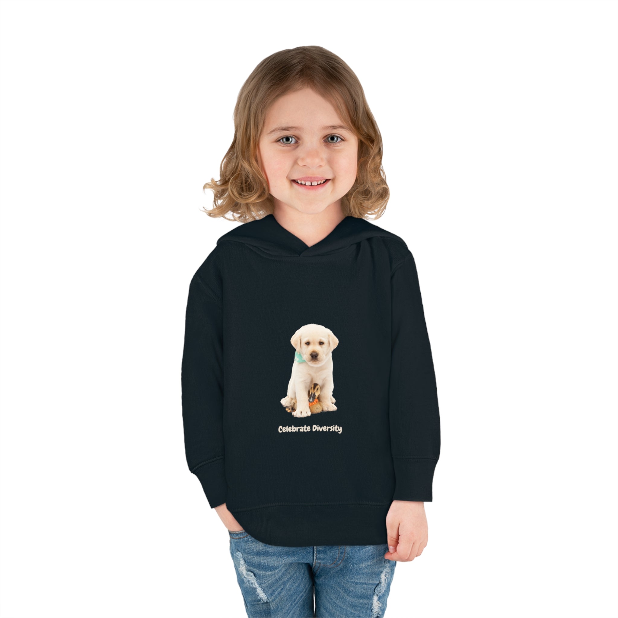 Toddler girl wearing black unisex hoodie with "Celebrate Diversity" inspired graphic with puppy and duck on front.
