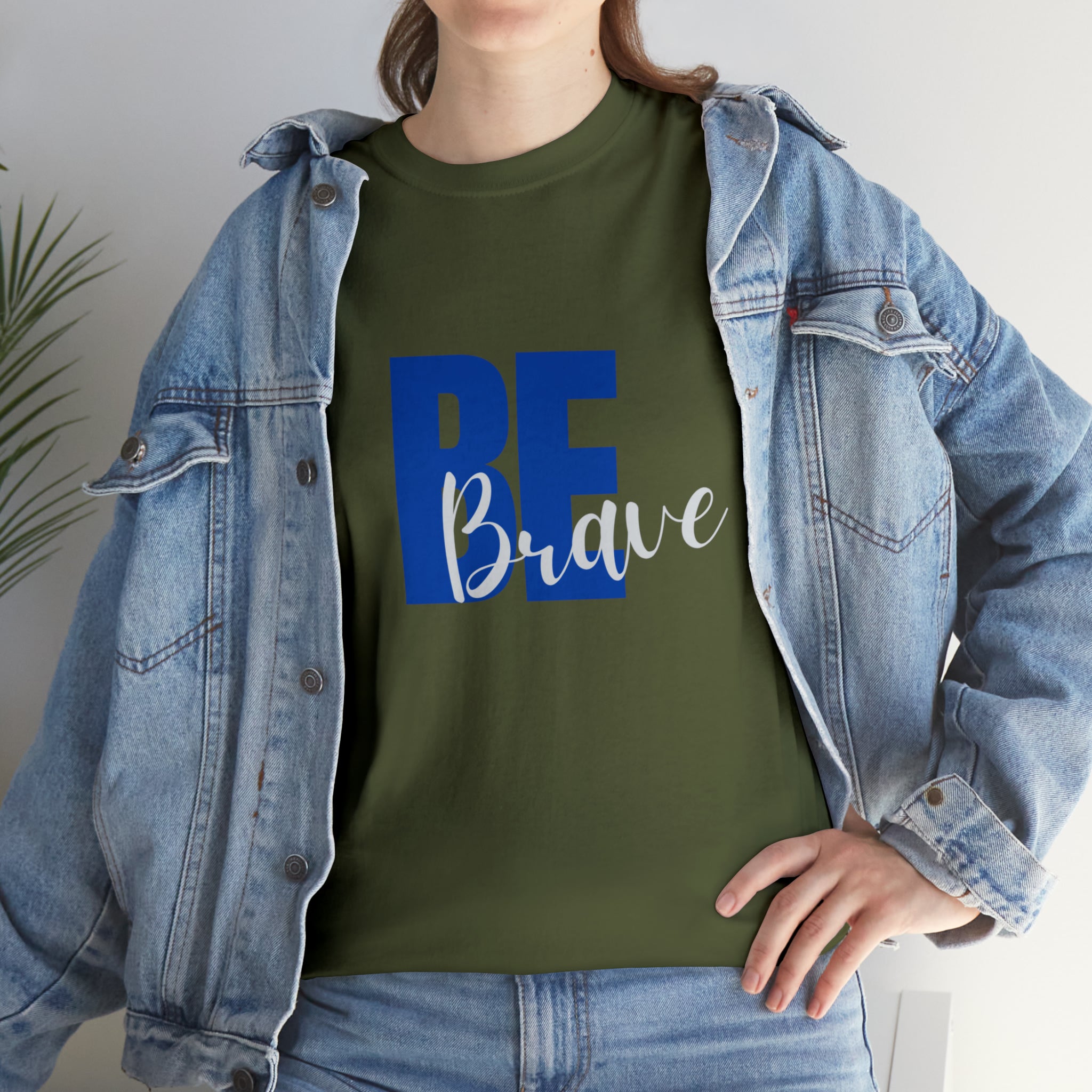 Adult women wearing military green T-Shirt and Jean jacket with "Be Brave" motivational image on front.
