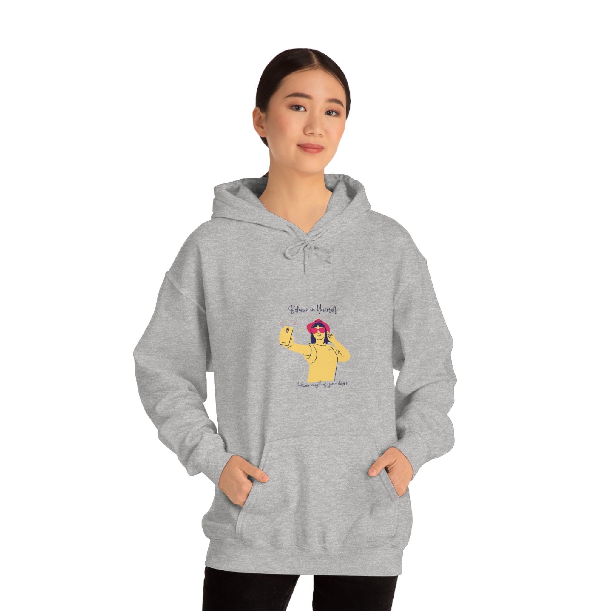 Adult female wearing sports grey hoodie with "Believe in yourself, Achieve anything you desire" girl taking picture of herself inspired graphic.