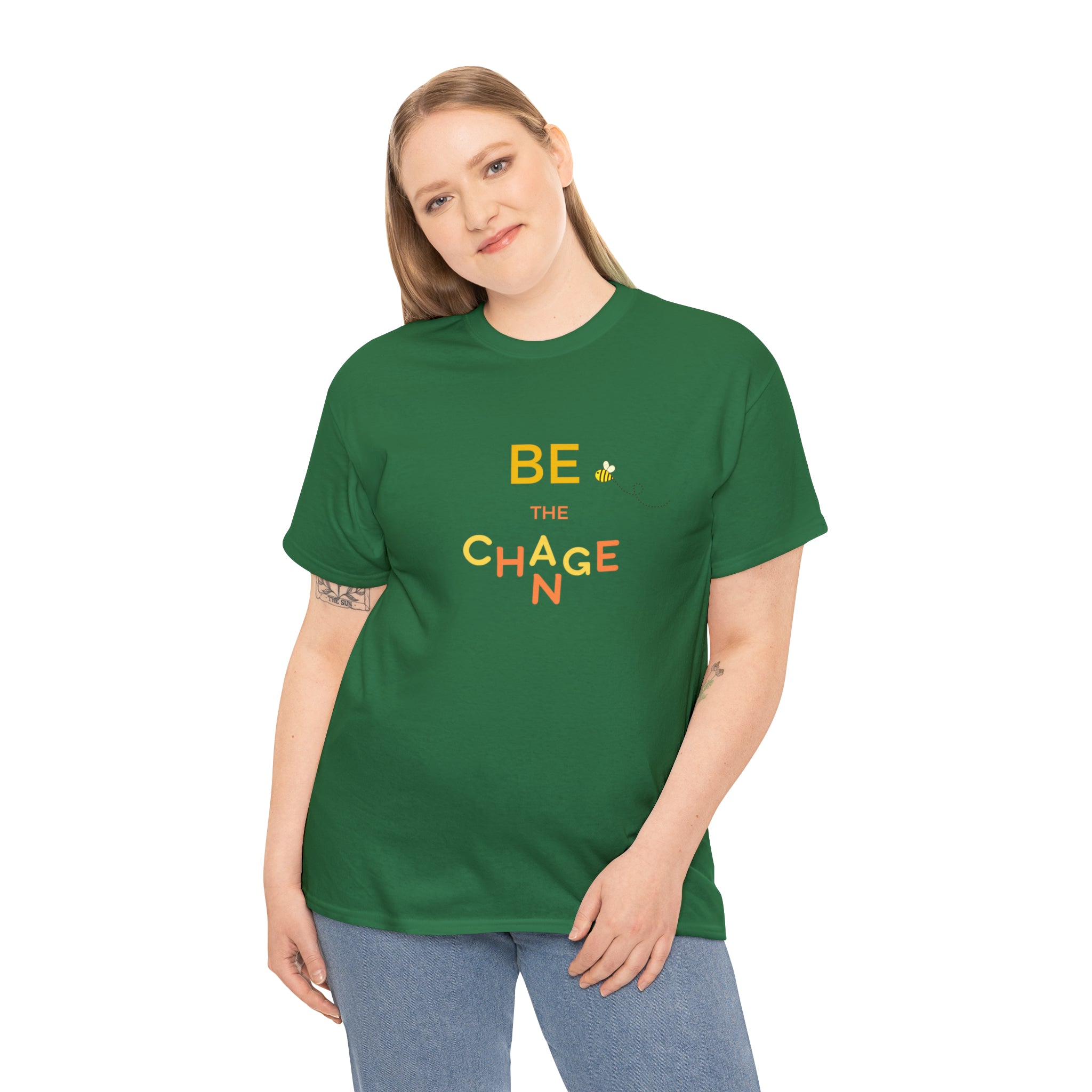 Adult Women wearing turf green T-Shirt with "Be The Change" motivational image on front.