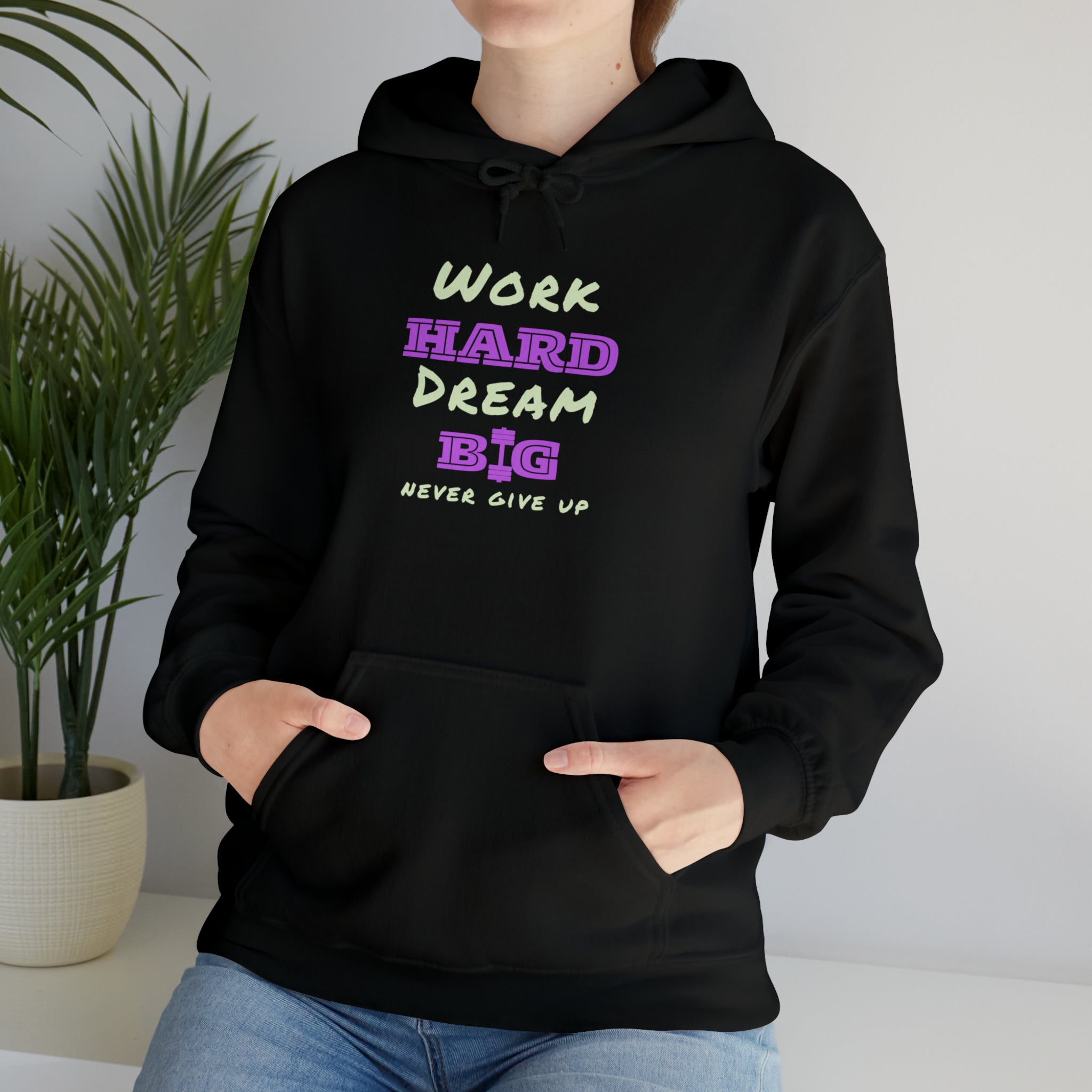 Adult Model wearing black  Hoodie with Work Hard Dream Big Never Give Up Image on front.
