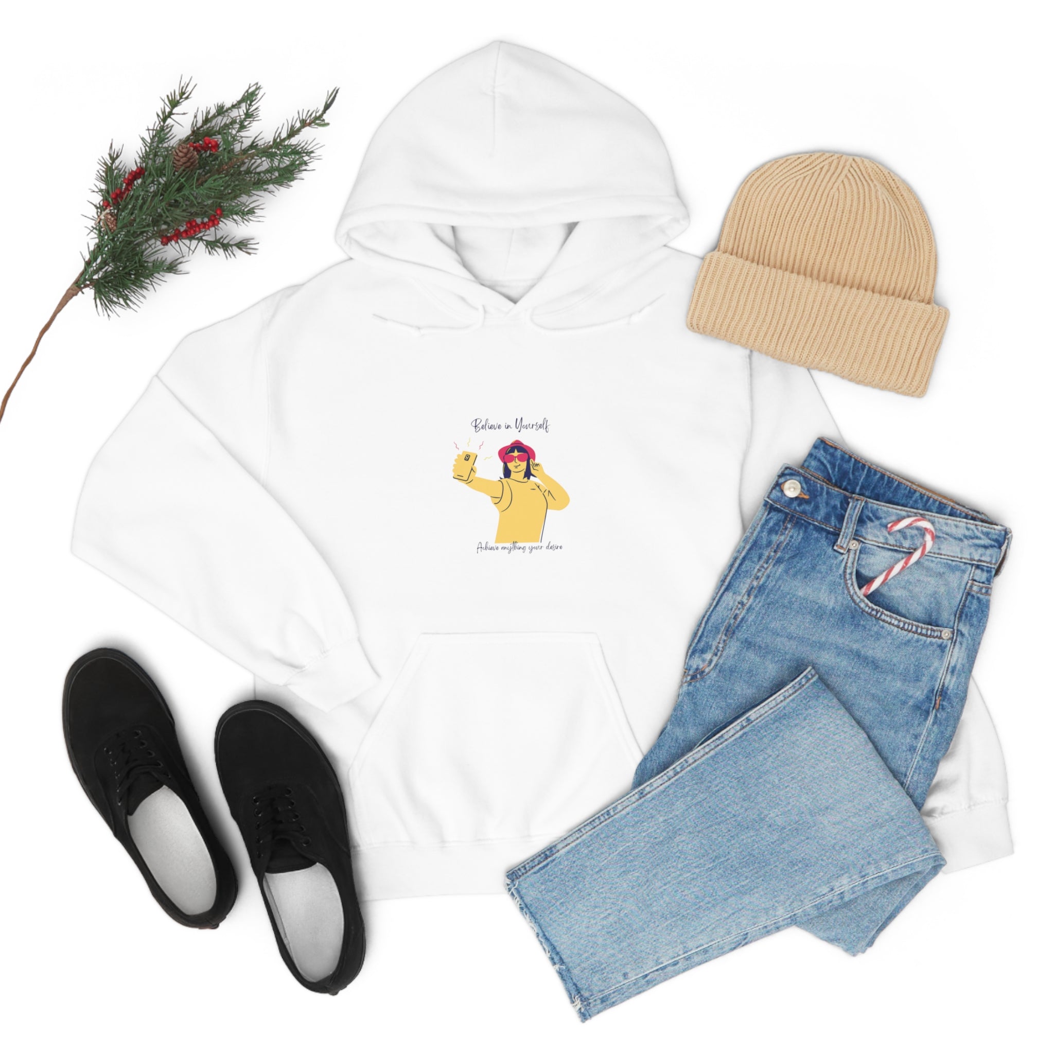 Adult female  white hoodie with "Believe in yourself, Achieve anything you desire" girl taking picture of herself inspired graphic, pair of jeans, tan hat and black sneakers