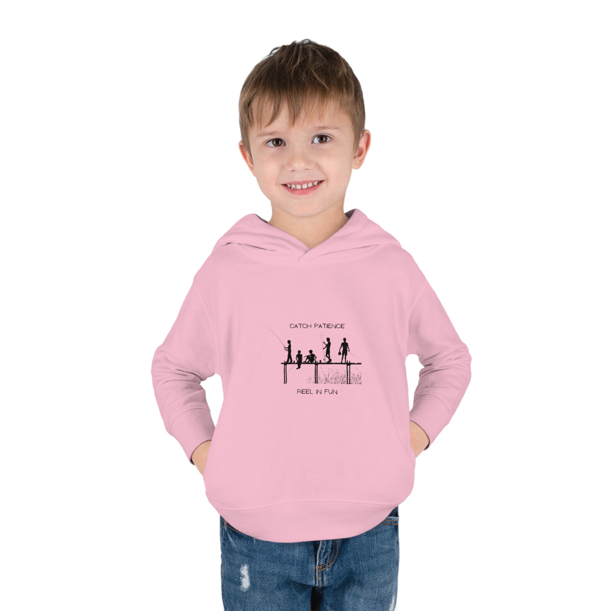 Boy Toddler unisex wearing light pink hoodie with "Catch Patience Reel in Fun" inspired graphic of people fishing.