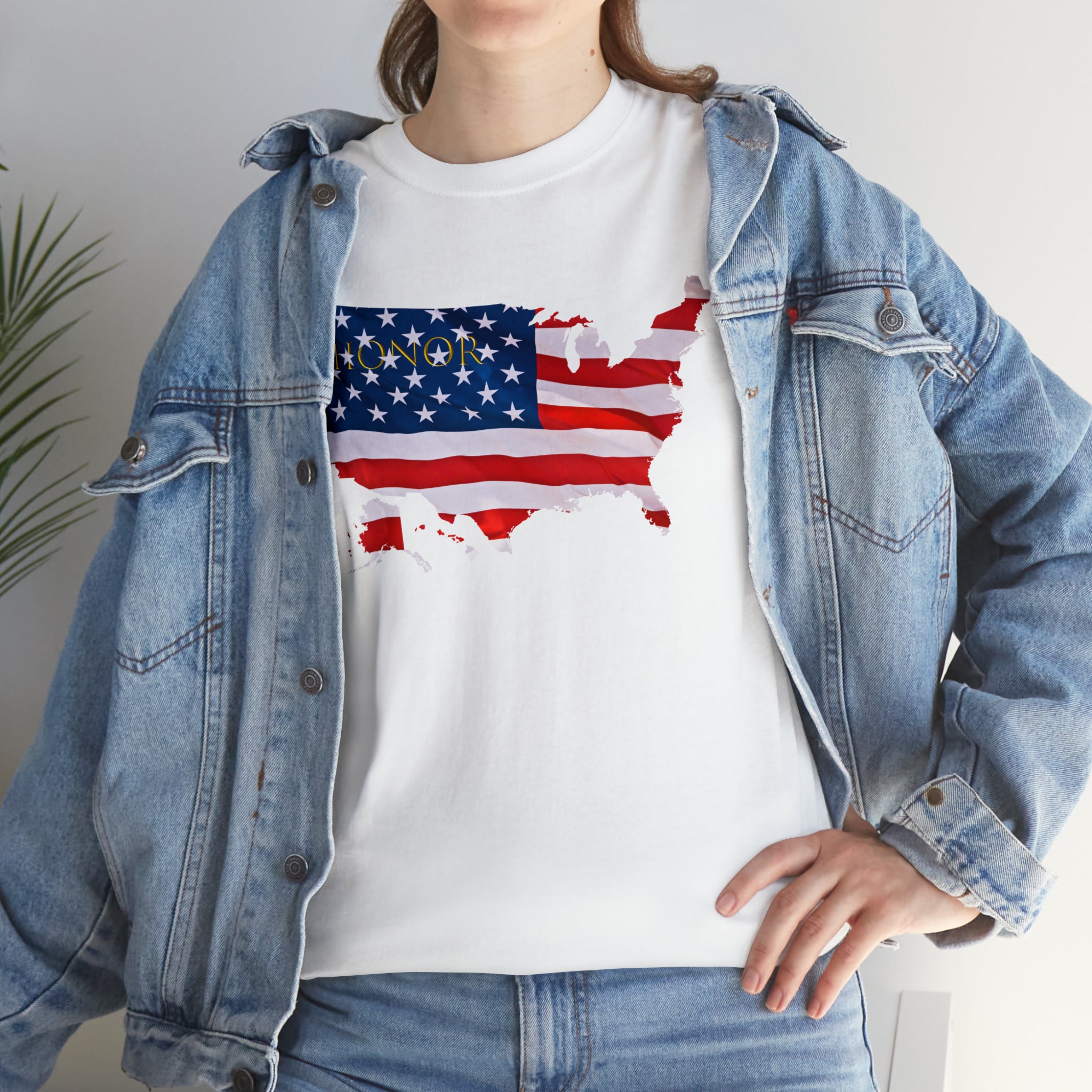 Adult female wearing white T-Shirt with "Honor USA" inspired American as a Flag graphic on front, with jean jacket