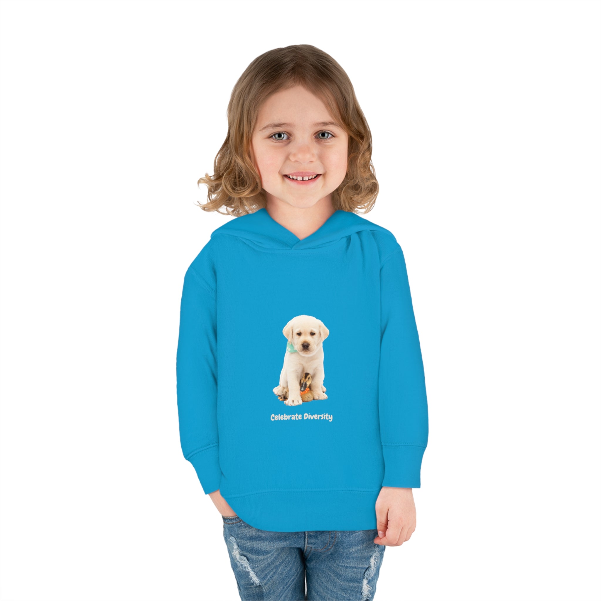Toddler girl wearing turquoise unisex hoodie with "Celebrate Diversity" inspired graphic with puppy and duck on front.
