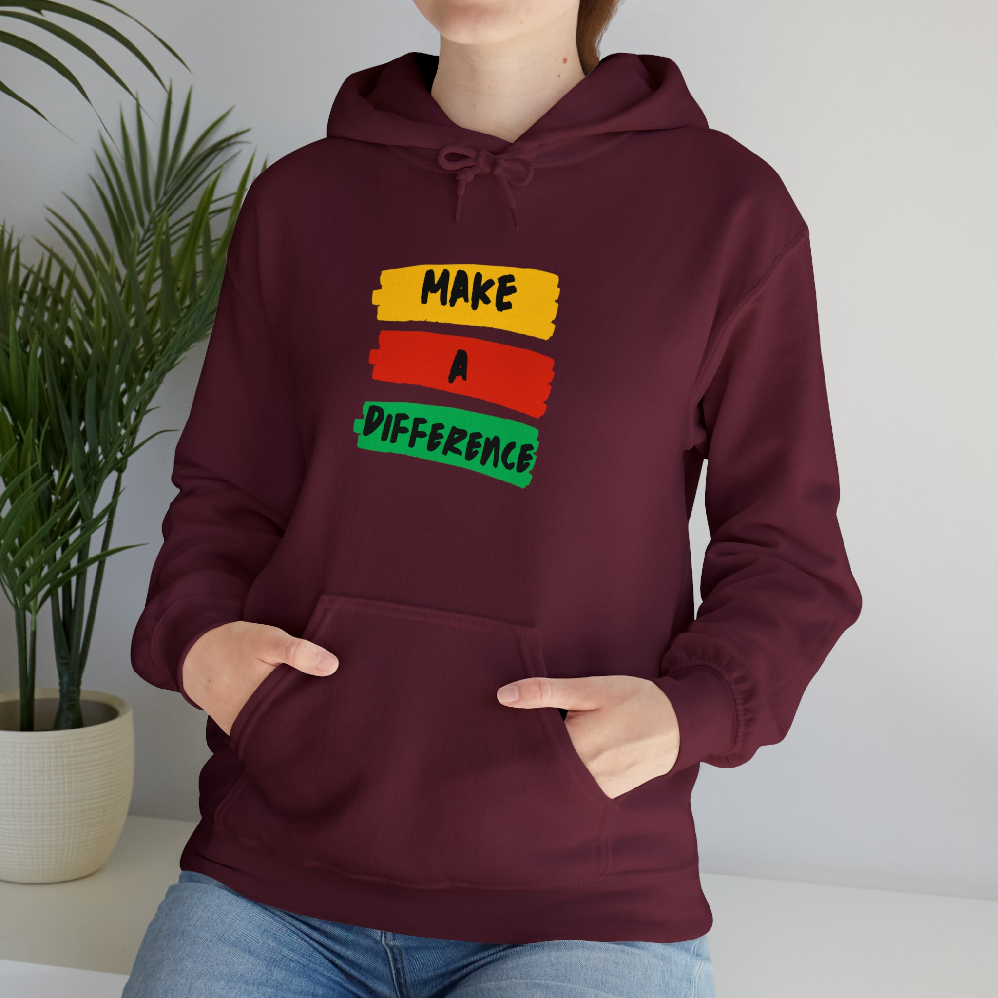 Adult female wearing maroon hoodie " Make A Difference" inspired images.