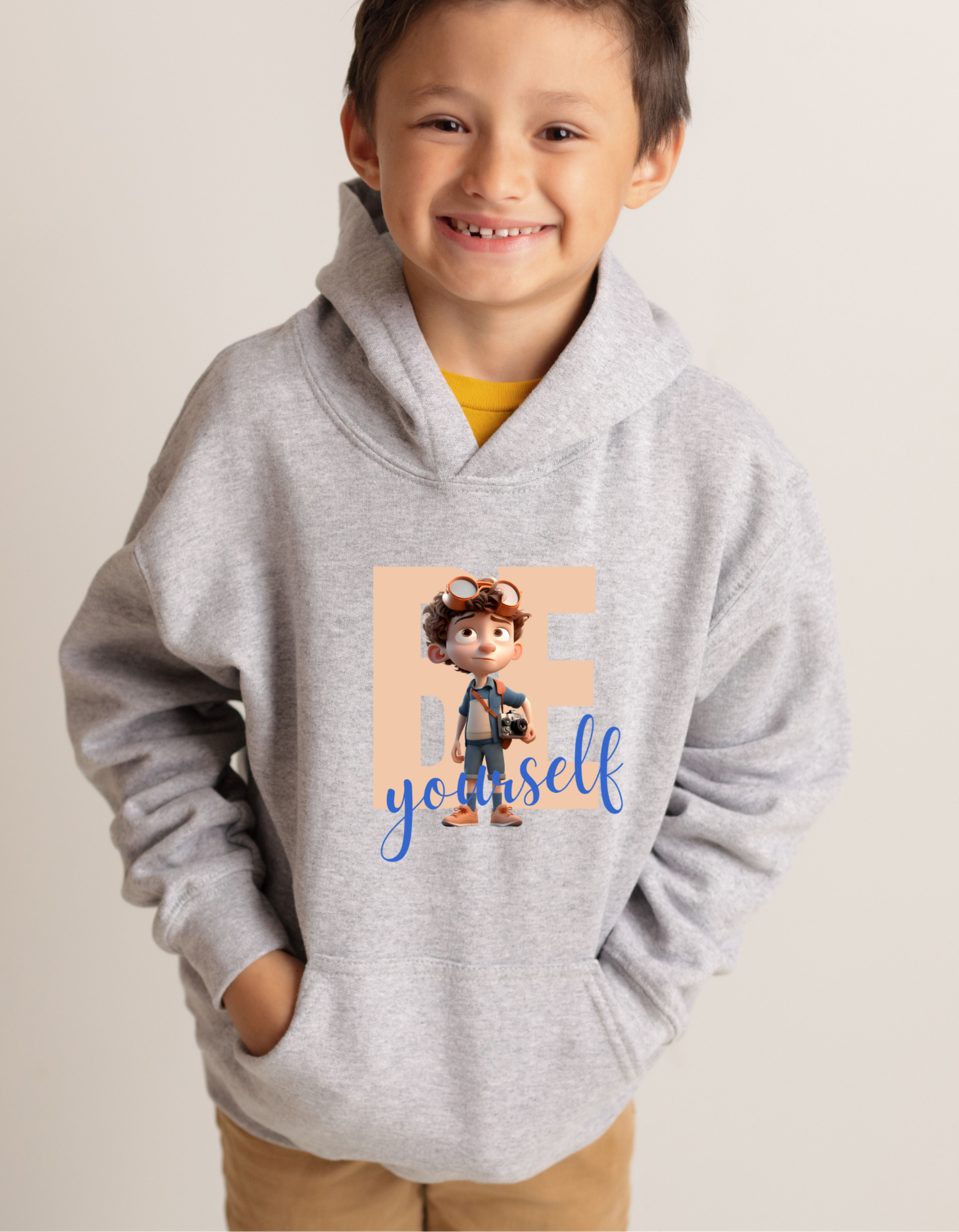 Youth boy wearing grey hoodie with "Be Yourself" motivational image on front.