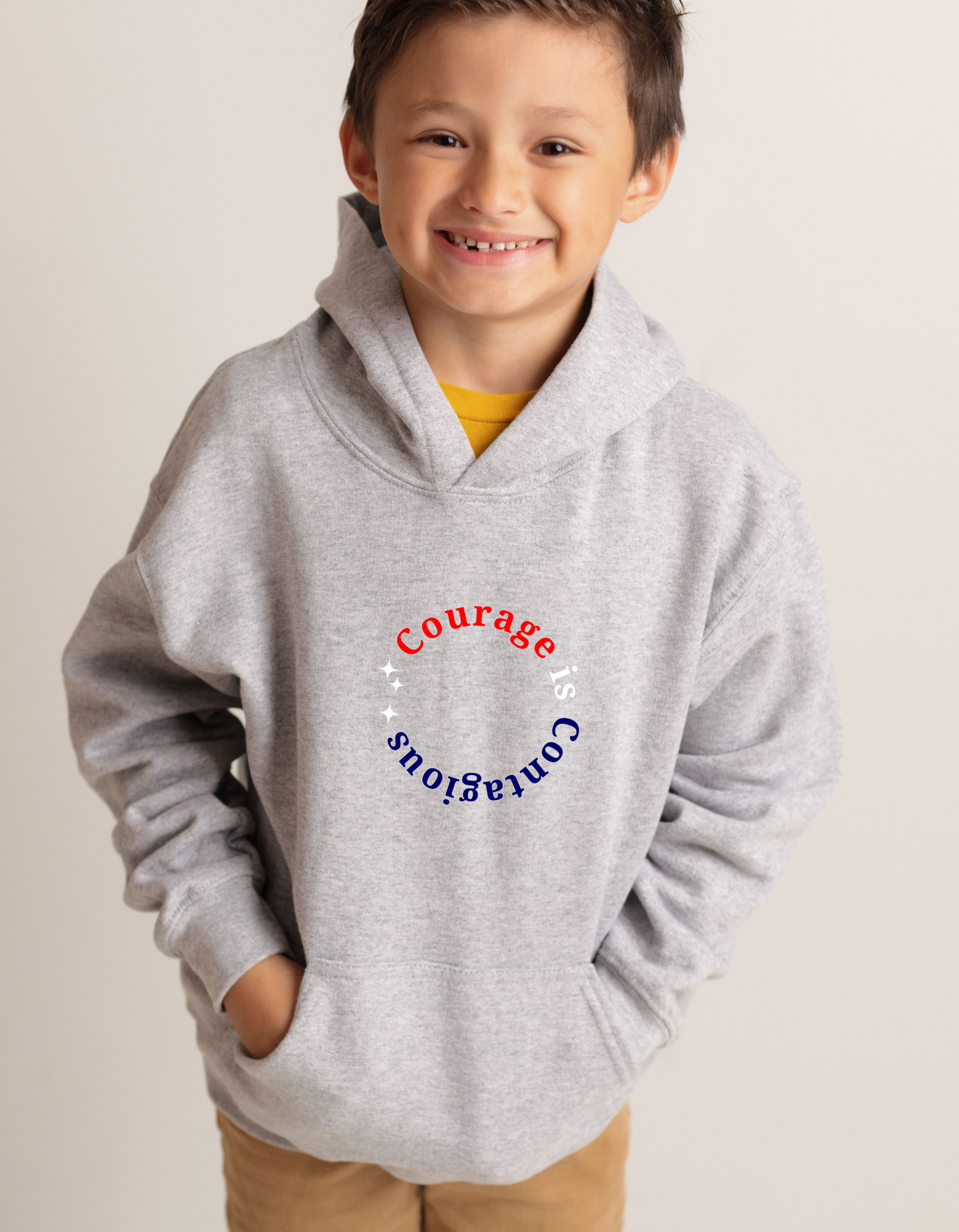 Youth boy wearing grey hoodie " Courage is Contagious" inspired message on front.